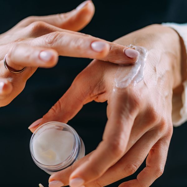 woman-applying-homemade-hand-cream-onto-her-hands-2024-10-20-18-24-38-utc